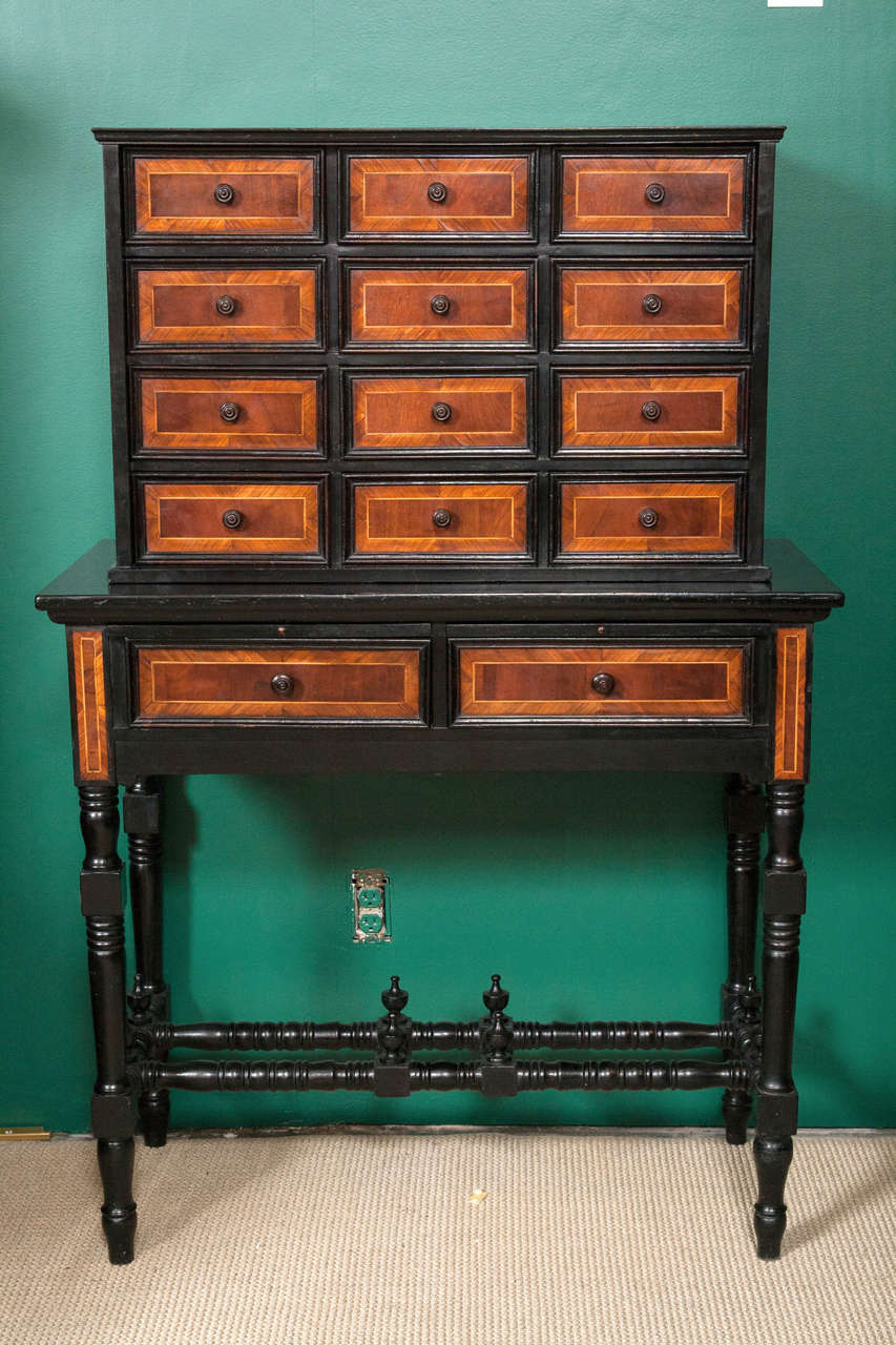 A 19th century English ebonized specimen cabinet on stand with rosewood inlay.