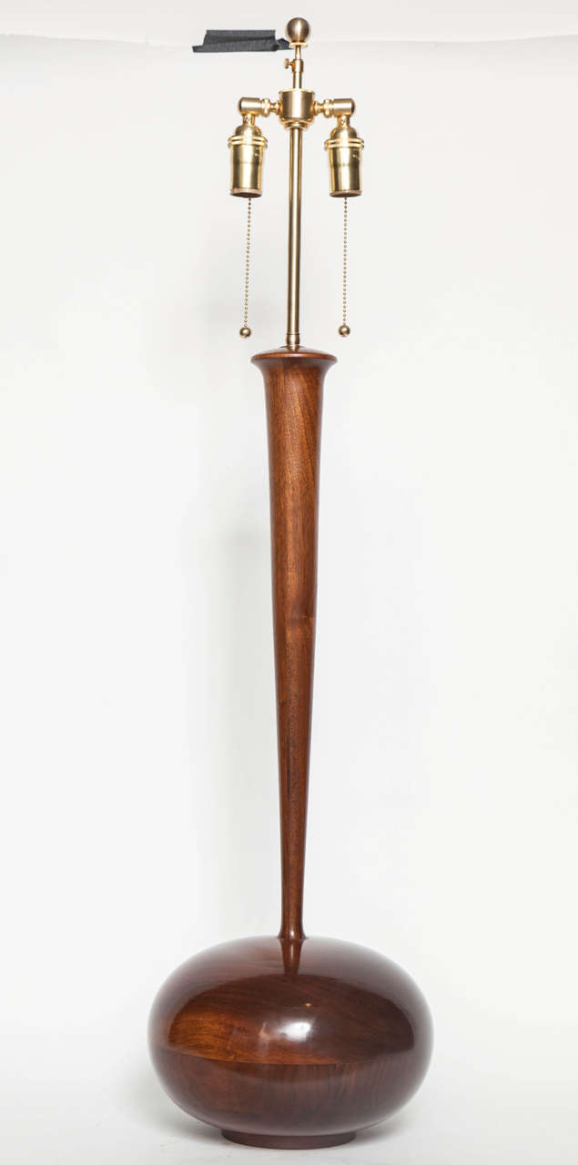 Deeply polished European walnut lamp body in the form of a flattened sphere supporting a flaring column, Italian, later 1950s. Newly repolished and rewired with two-socket cluster for US usage. Measures: Height 42", lamp body: 29.5" high.