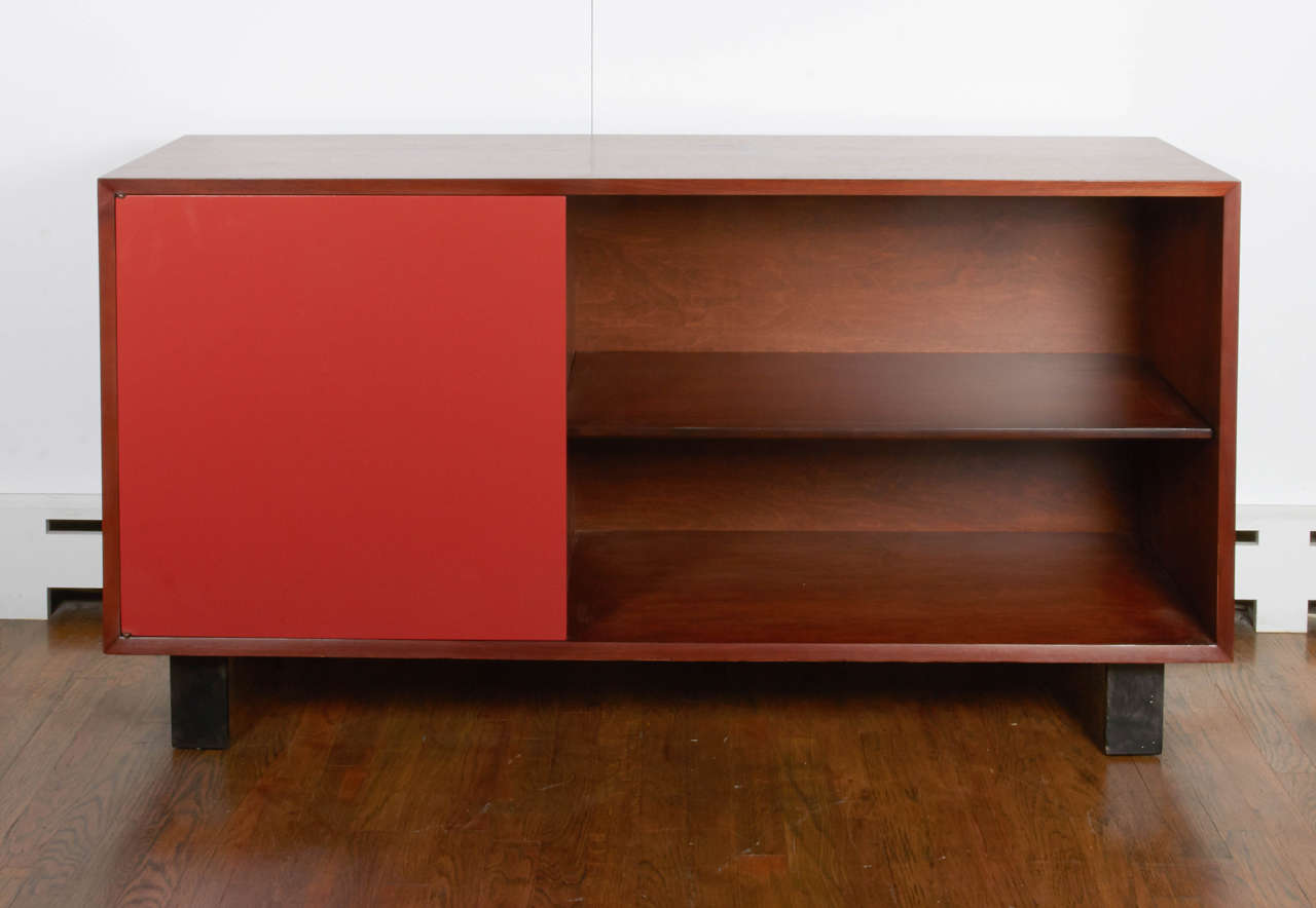 George Nelson walnut bookcase with red door and open cabinet, mfg. Herman Miller-1950’s.