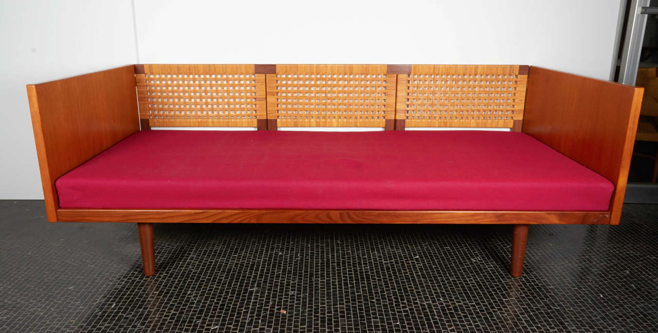Rare Hans Wegner daybed in teak with cane back, 1960s. Imported from Denmark by original owner.