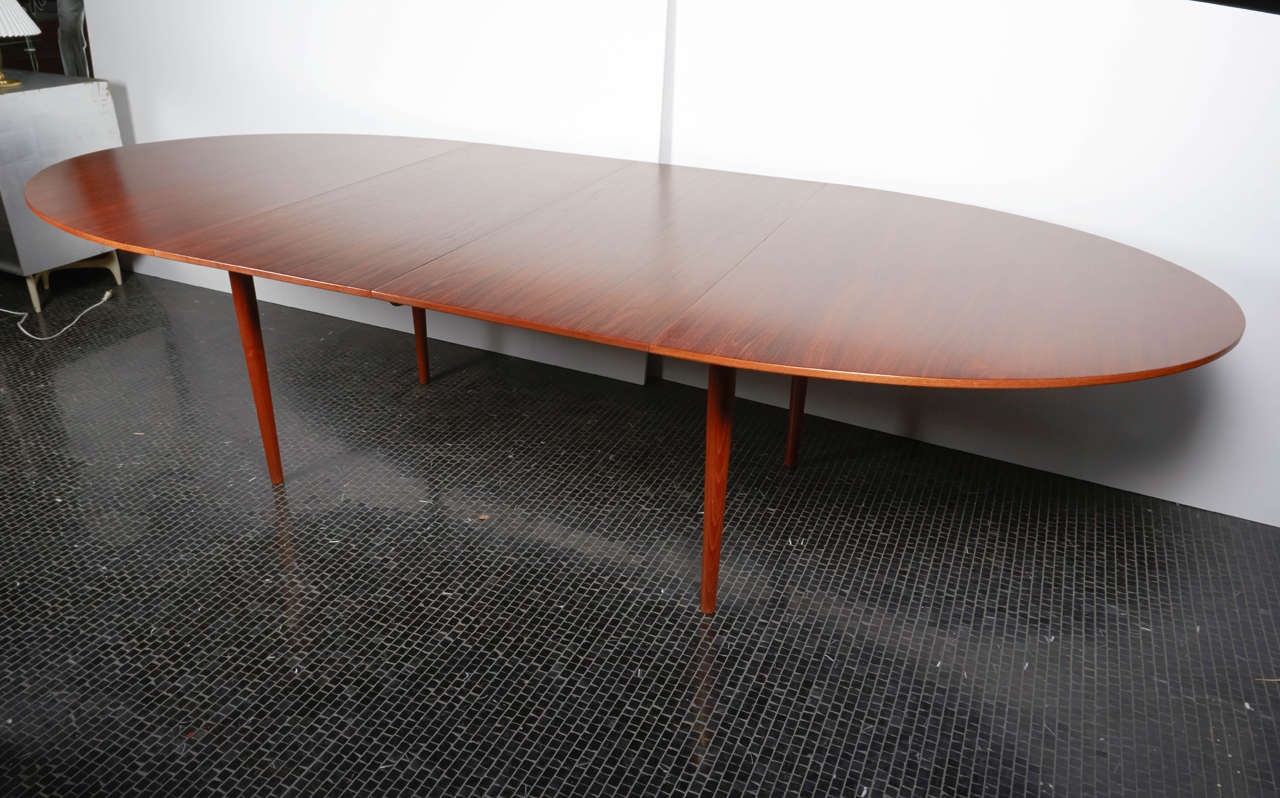 Finn Juhl teak dining table with branded manufacturer's mark to underside: [cabinetmaker Niels Vodder, Copenhagen, Denmark design Finn Juhl].
