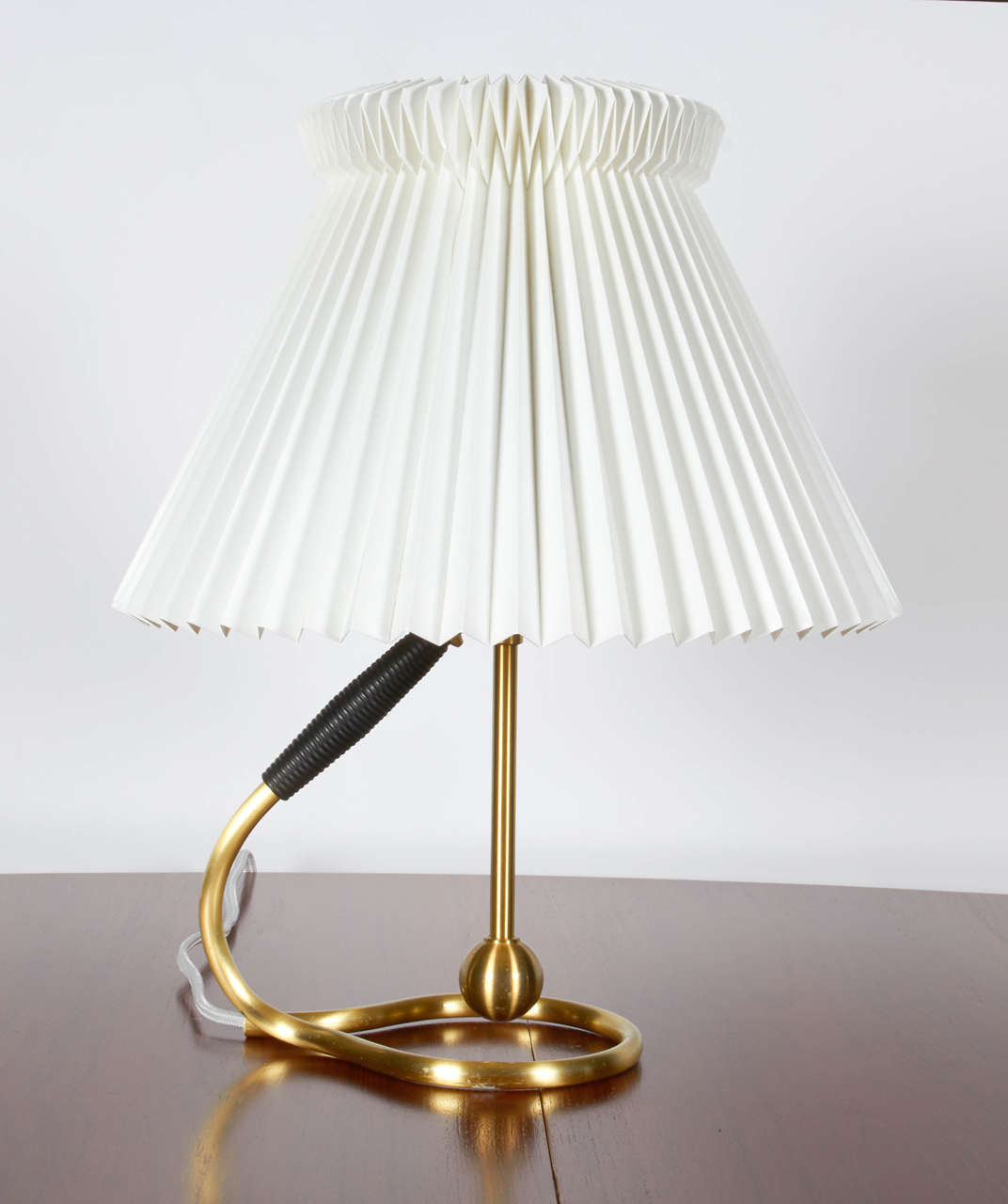 Pair of vintage Kaare Klint table lamps.  With its tilt function, it easily converts from a wall lamp to a table lamp, and vice versa.  These lamps were purchased from the original owner who brought them back from Denmark in the 1960's.