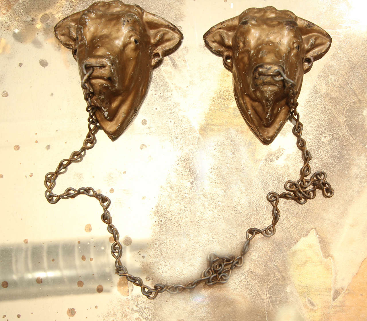 Handsome 19th century decorative utensil chain from Italian butcher shop. Mount to butcher block to hold utensils or mount on wall as decoration. Beautiful patina and wear on bull heads and chain with rings through bull's nostrils.