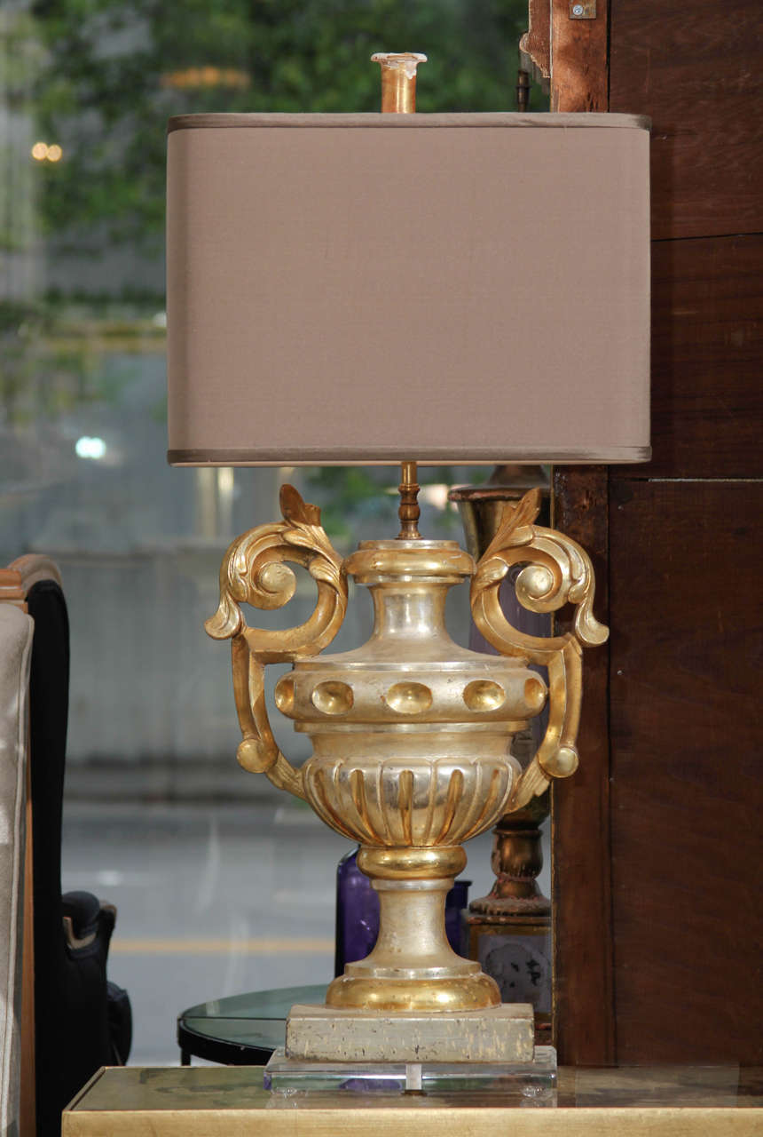 Pair of custom lamps of gilded carved wood fragments from France on plexiglass bases with oval silk shades.