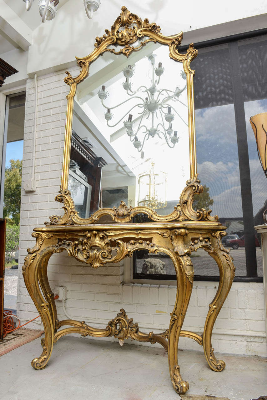 This is a superb marble top console table with the original mirror above, made in France circa 1890.
This has the original gilt to the console and the mirror and also the marble top.
To the top of the mirror and console it has the some crest, they