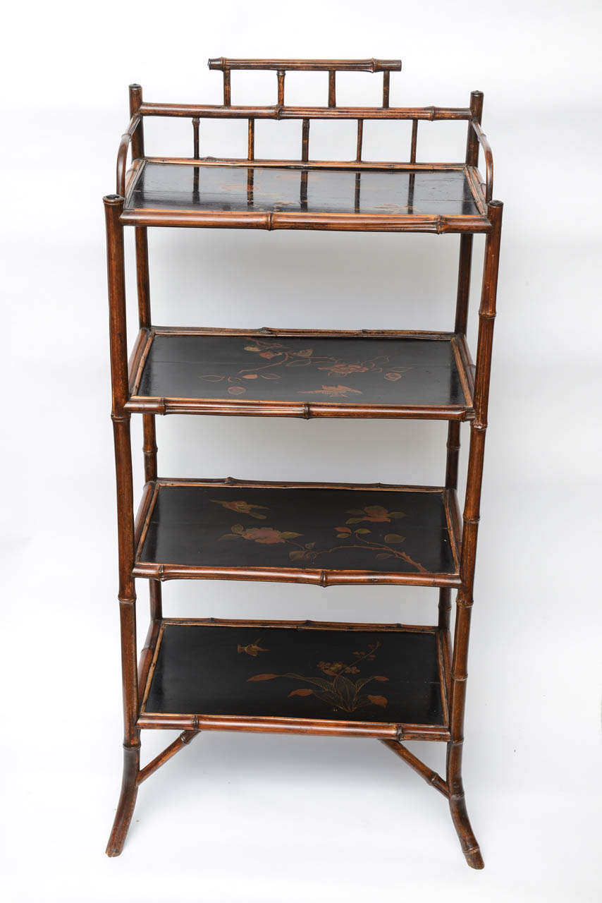 Its a very sophisticated English bamboo étagère with japanning on the three tops.