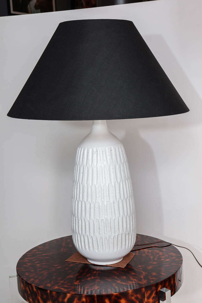 Large ceramic table lamp with incised textured decoration and white glaze. 
Signed with DT mark 
American, c. 1950