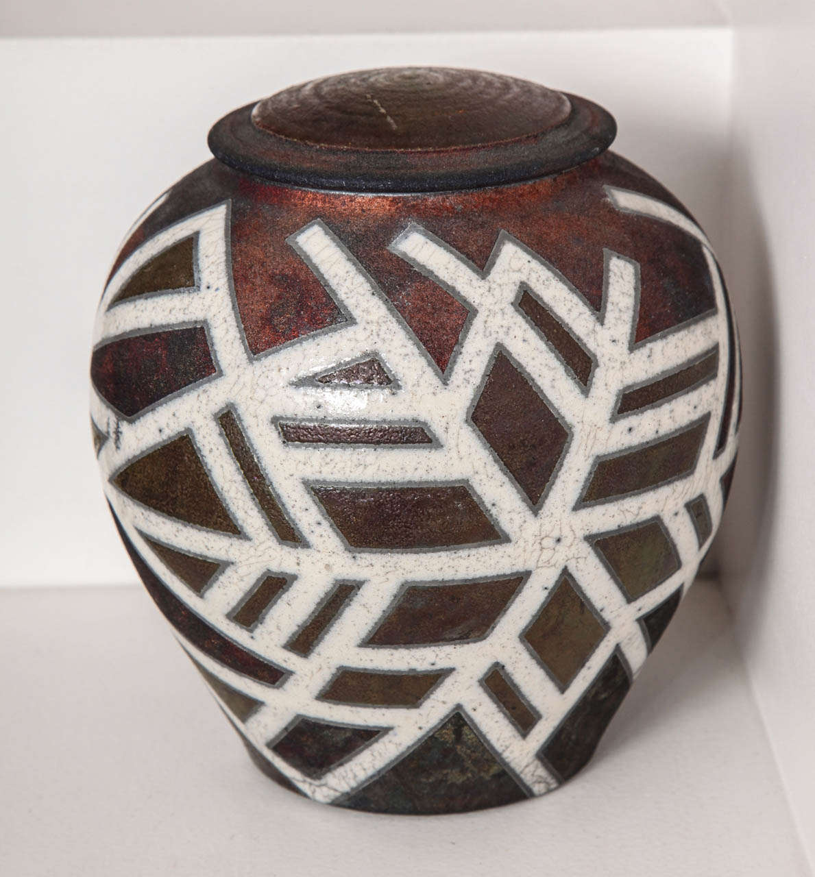 Deborah Slahta. 
“Cinnabar Snowflake” covered raku jar.
Signed and dated 2006. 
 
A Pennsylvania based potter, Deborah Slahta specializes in raku and stoneware pottery. Slahta uses the vessel form as a three-dimensional canvas, playing with