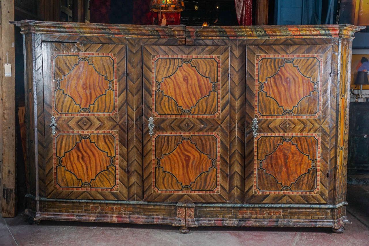 A monumental armoire, hand-painted with faux grain, made of wide bavarian planks of pine.