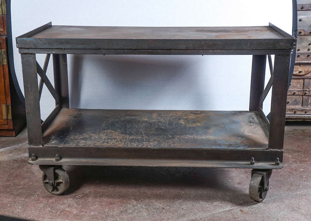 An Industrial steel rolling cart from Bethlehem, Pennsylvania, can be utilized as a bar cart, a kitchen island, or a console table. Equipped with wheels, it can be easily moved. Original patina.