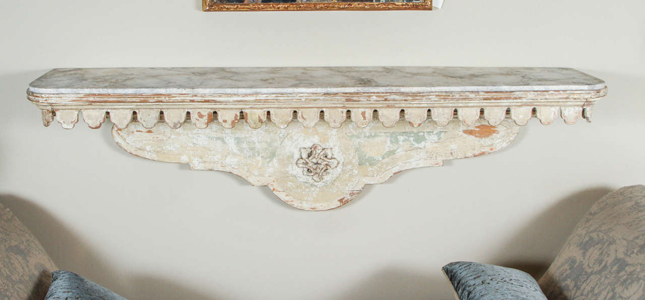 This was most likely was originally an over the door console table or shelf, but can be used as a wall-mounted console table. 18th century Italian with scalloped edge detail and new faux marble top.