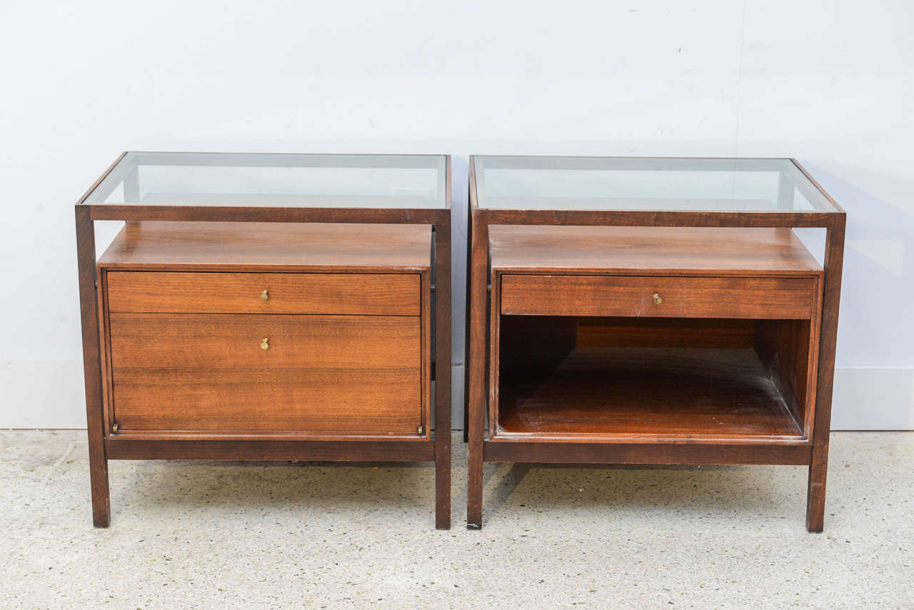 One with one drawers and two false drawers as a drop down and one with one drawer and an open area, both with glass tops.