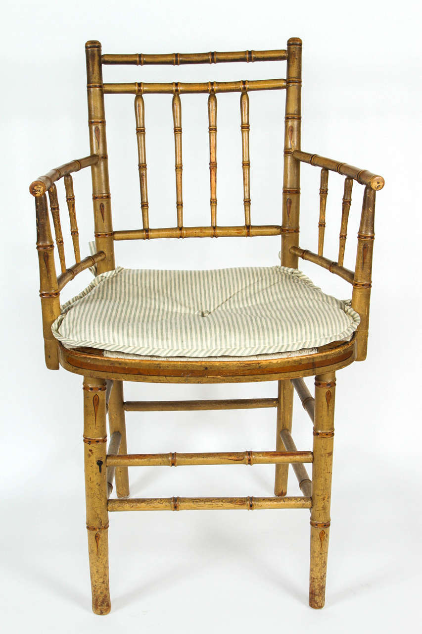 An English Regency faux bamboo armchair with new cushion in Rose Tarlow Gigi glazed linen stripe.  