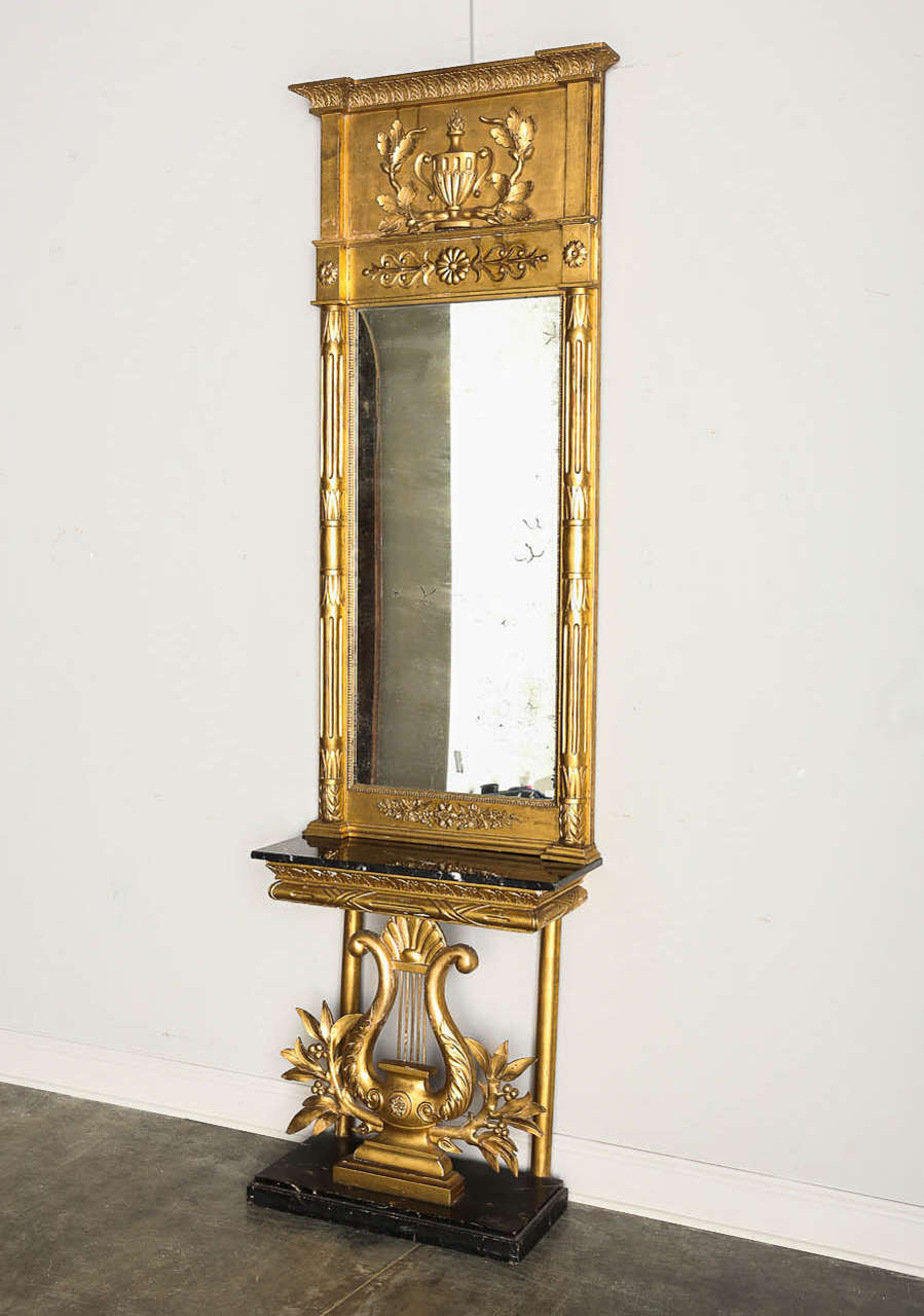 Classic Gustavian style console and mirror in gold gilt with original mercury glass mirror, marble and gilt. Base is possible early replacement.

Established in 1979, Joyce Horn Antiques, ltd. continues its 36 year tradition of being a family