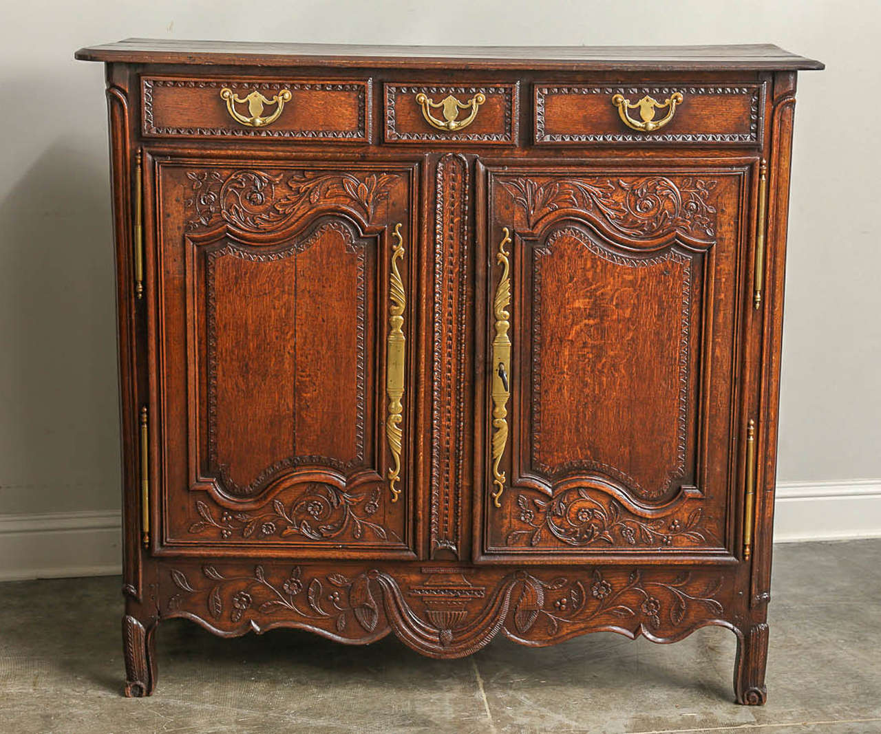 19th century French Louis XV style bahut in oak. Charming normand high buffet with wonderful carving and indigenous normand oak.

Established in 1979, Joyce Horn Antiques, ltd. continues its 36 year tradition of being a family owned and operated