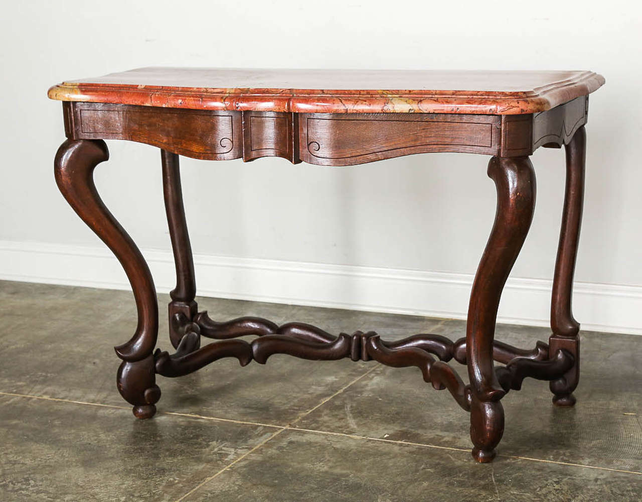 Mutton bone style console in Louis XIV style with cross stretchers in dark oak and original marble top. 

Established in 1979, Joyce Horn Antiques, ltd. continues its 36 year tradition of being a family owned and operated business specializing in