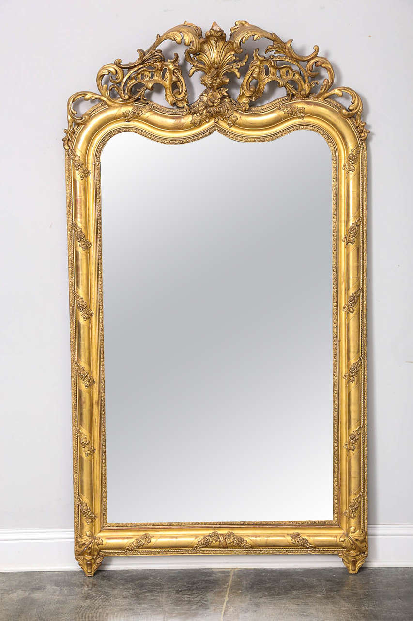 French gold gilt mirror in the style of Louis XIV from France beautiful mirror with double arched top and lovely pierced, Louis XIV style cartouche; original gilt.

Established in 1979, Joyce Horn Antiques, ltd. continues its 36 year tradition of