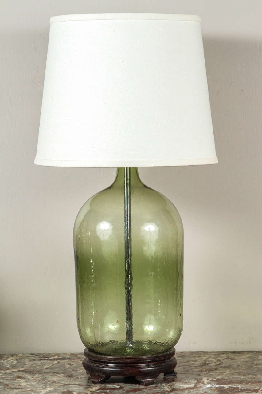 A large glass bottle lamp with custom shade.