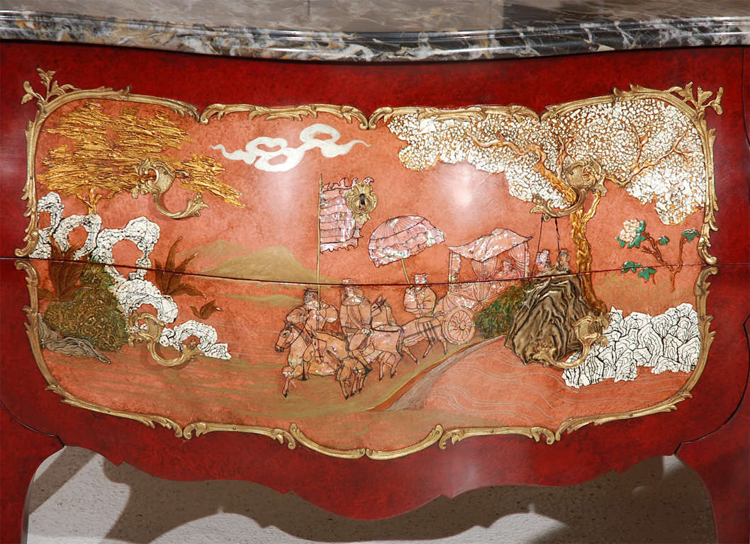 A beautiful paint decorated two drawer chest including Mother of Pearl inlays, raised lacquer work, and Eggshell Lacquers.  The front of the chest depicts Chinese royalty in procession while the sides feature Chrysanthemums in raised lacquer work. 