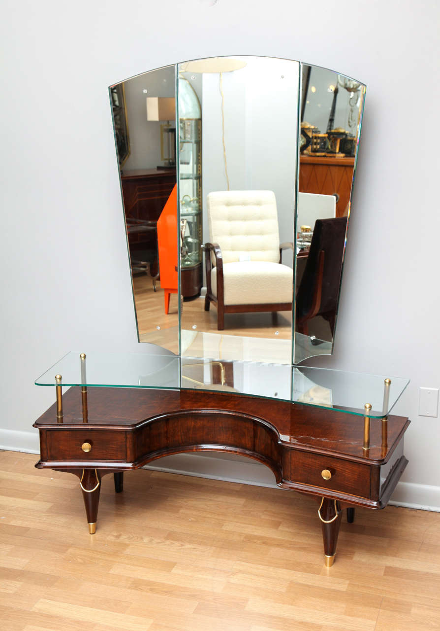 Fabulous Art Deco coiffeuse/dressing table with original adjustable three way mirror. Floating glass table top. Original details include rosettes on mirror and brass sabots.