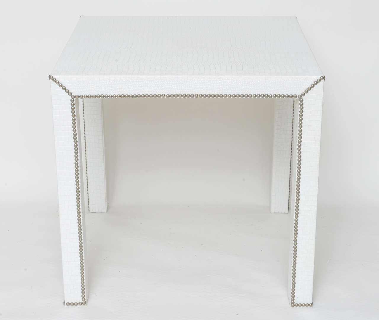 Card and game table in white faux crocodile with studded trim. Excellent sturdy game tabe for those exciting and sometimes (raucous) parties.