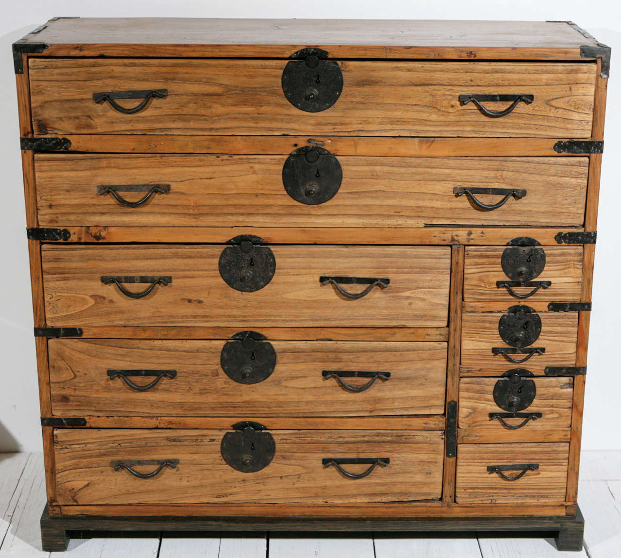 Japanese Tansu chest of nine drawers. Dry kiri wood finish. Original iron fittings and hardware.
