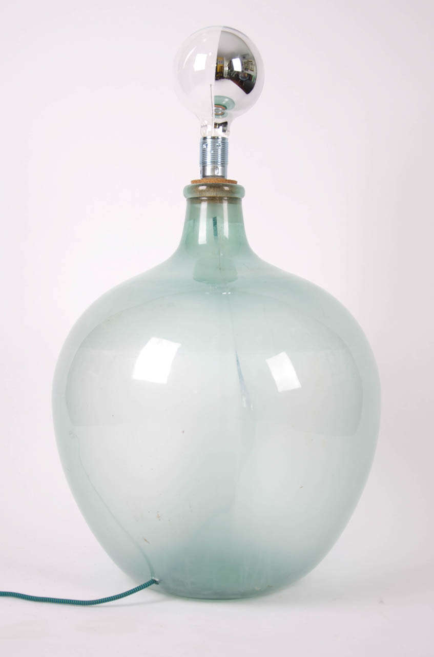 An early 20th century demi-john, re-worked into a floor lamp.
This is a very large demi-john.