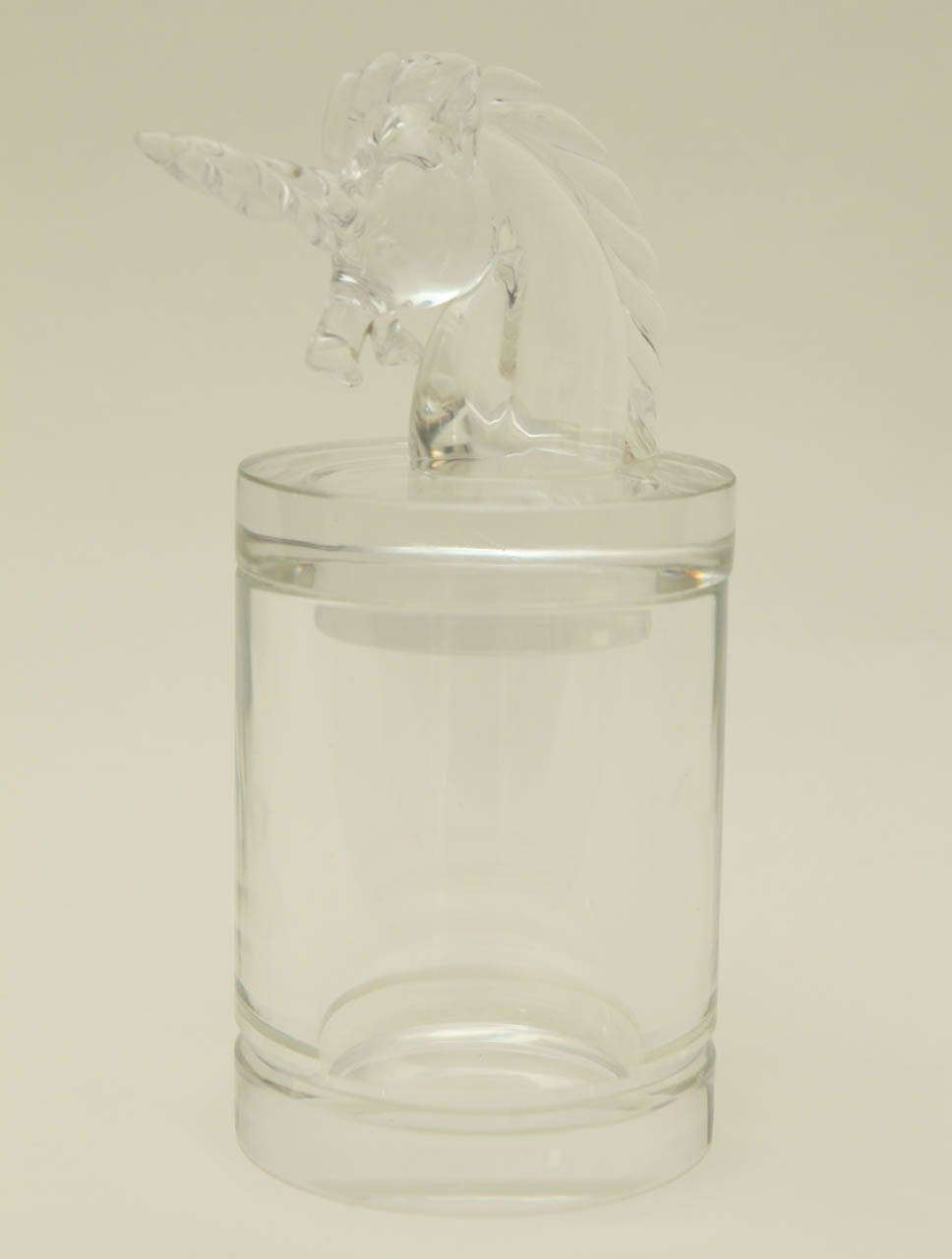 A fanciful unicorn tops the lid of this crystal container with a beveled detail at the base. The Cartier signature is etched on the underside of the container.