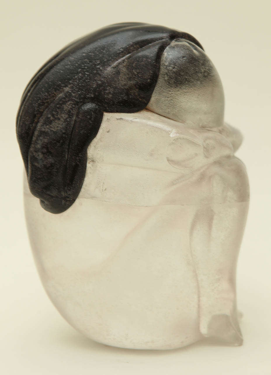 A lovely Murano scavo glass sculpture of a woman with long black hair, depicted with her knees tucked up to her chest and her arms and head resting on them. The sculpture is made of three pieces of glass annealed together. The sculpture has a