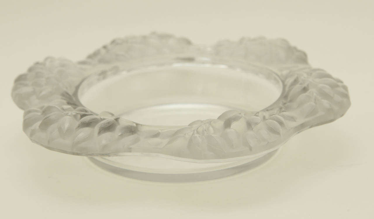 A beautiful crystal wine coaster with a raised satin frosted branch motif. Although we have not been able to identify the pattern, we believe it to be the work of Marc Lalique. It is signed on the bottom 