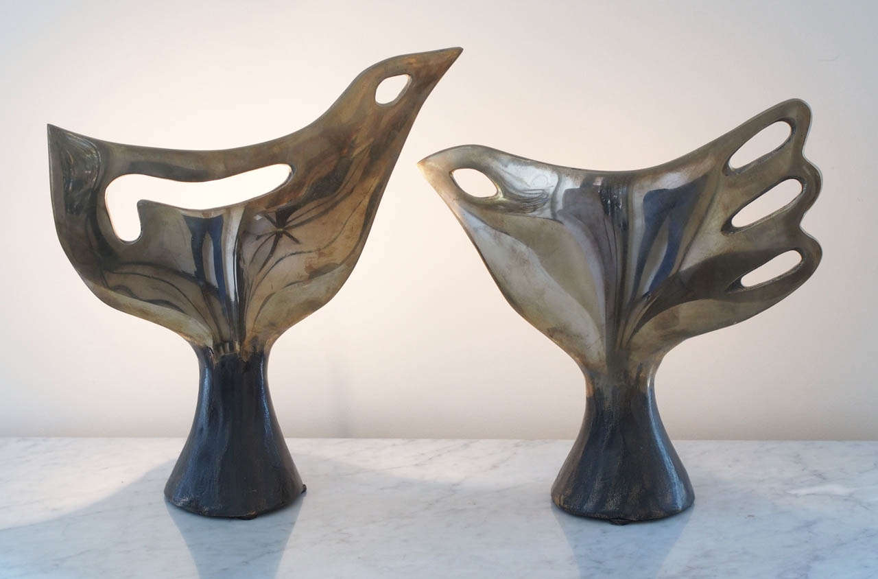 Two rare and exceptional table lamps in solid bronze, polished at the body and aged at the base, of stylized bird form; wired to US standard; each signed 
