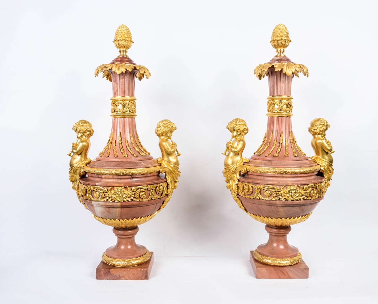 very unusual pink marble garniture in shape of  urns, ornamented with bronze gilt with real gold.