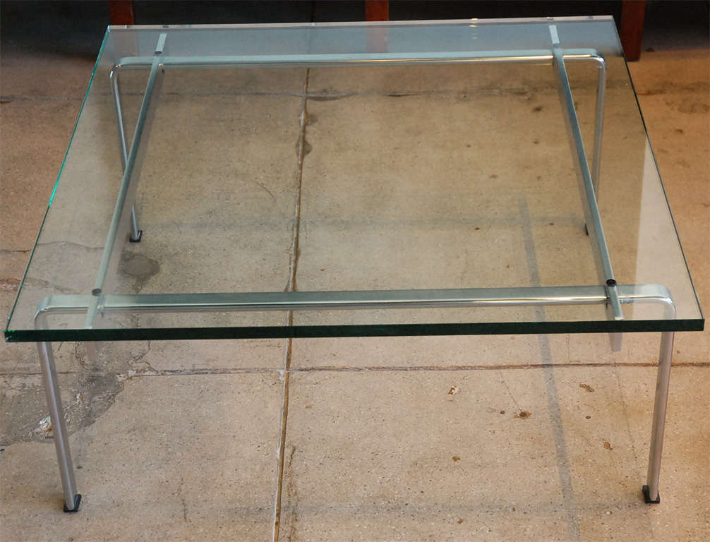 a stainless steel frame & glass top coffee table from danish designers fabricius & kastholm.