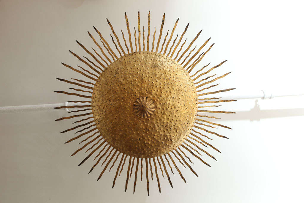 A gilt metal sun sconce lighting fixture for the ceiling, circa 1950's