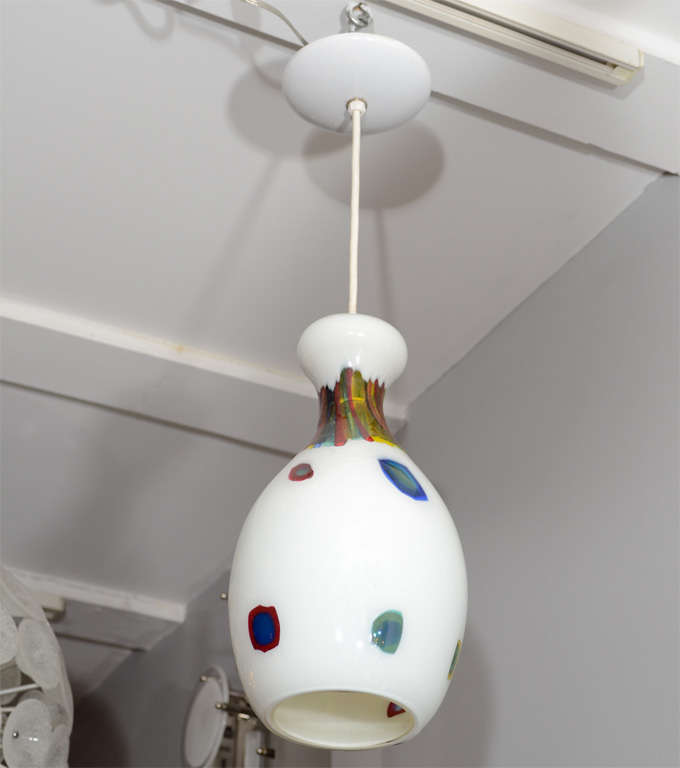 Set of two white bulbous hanging light fixtures designed by Anzolo Fuga for A.V.E.M. (Arte Vetrario Muranese) circa early 1960's.  Yellow, red and blue canes on White Lattimo ground.   13