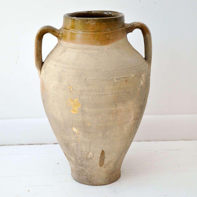 French terracotta olive jars varying in size and color. Three smaller jars with one handle and three larger jars with two handles. Jars range in size from 7.5