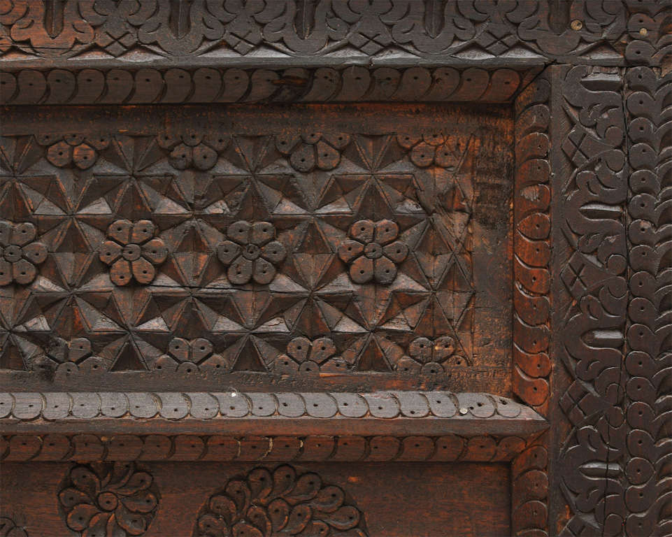 Hand carved bookcase with three shelves and four drawers. The carved detail resembles that of Indian architecture. The top is removable and there is a hidden carved out space for valuable items.