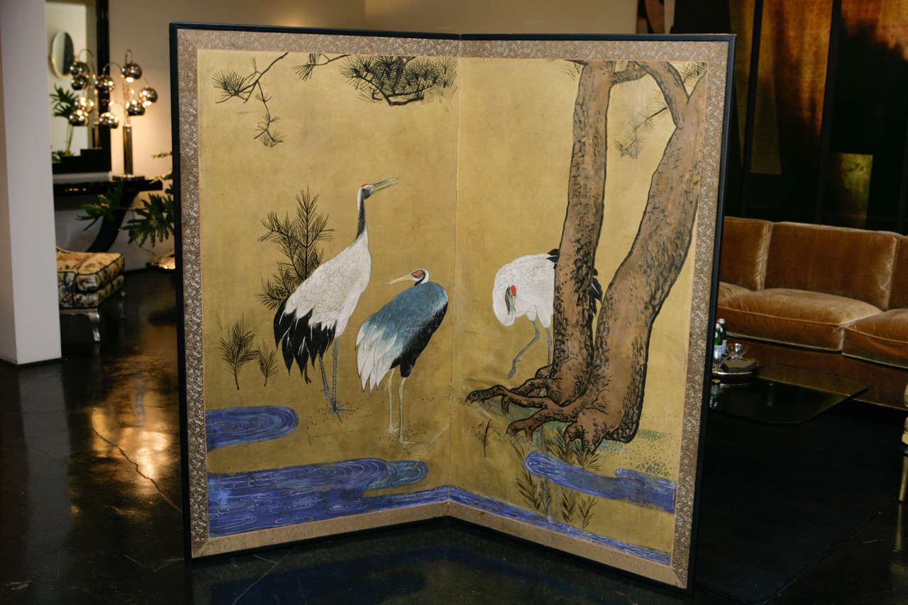 Beautiful 2-panel Japanese Screen with crane motif and gold background. Ornate fabric as border with gold dust sprinkled on surface of screen. Created in the Meiji period (1868-1912).