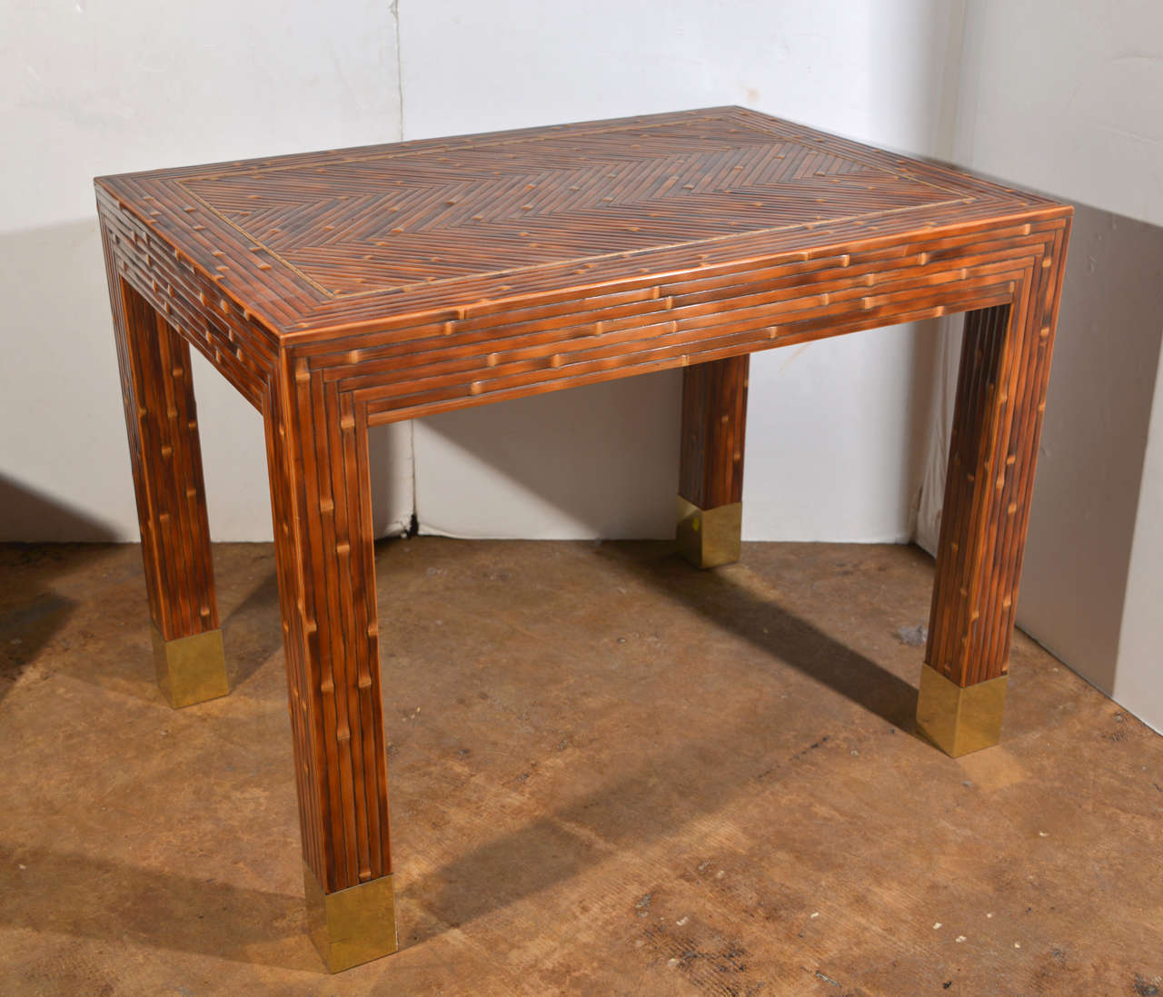 Classic Flint Harrison original condition stylish game table.  Nice mellow patina and contrast.  Superb craftsmanship.  Custom speckled bamboo with brass sabots.  Functional as corner or lamp table and small desk.

Founded in 1976, Flint Harrison