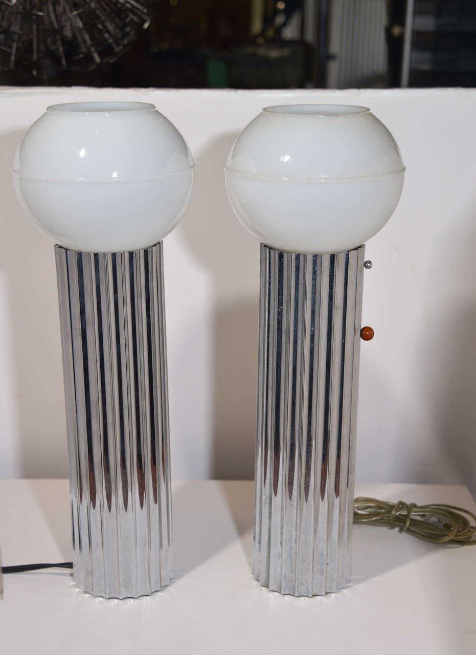 Machine Age Art Deco pair Signed Von Nessen, Nessen Studio fluted chrome table lamps price reduced

USA, c. 1930
Chrome-plated brass, glass, Bakelite/Catalin knobs
Iconic early Nessen fluted design

Signed with impressed manufacturer's mark to