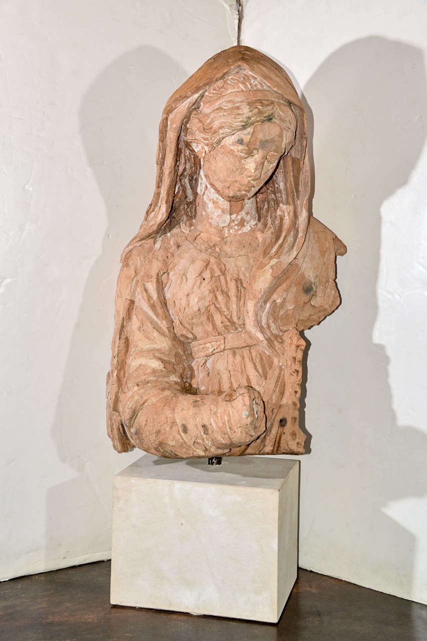 Large French 18th century terra cotta madonna fragment, mounted on a limestone block.