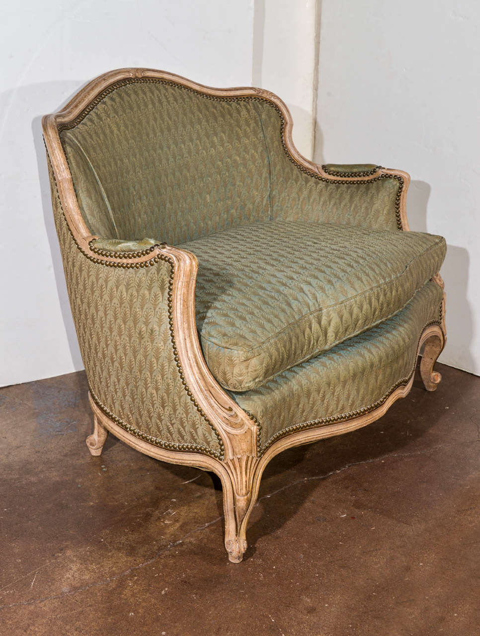 Small Louis XV style settee upholstered in vintage green Fortuny fabric.