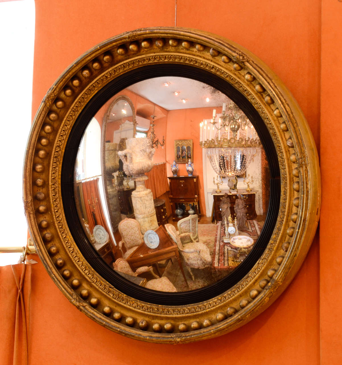 Gilt and ebonised wood and convex mirror