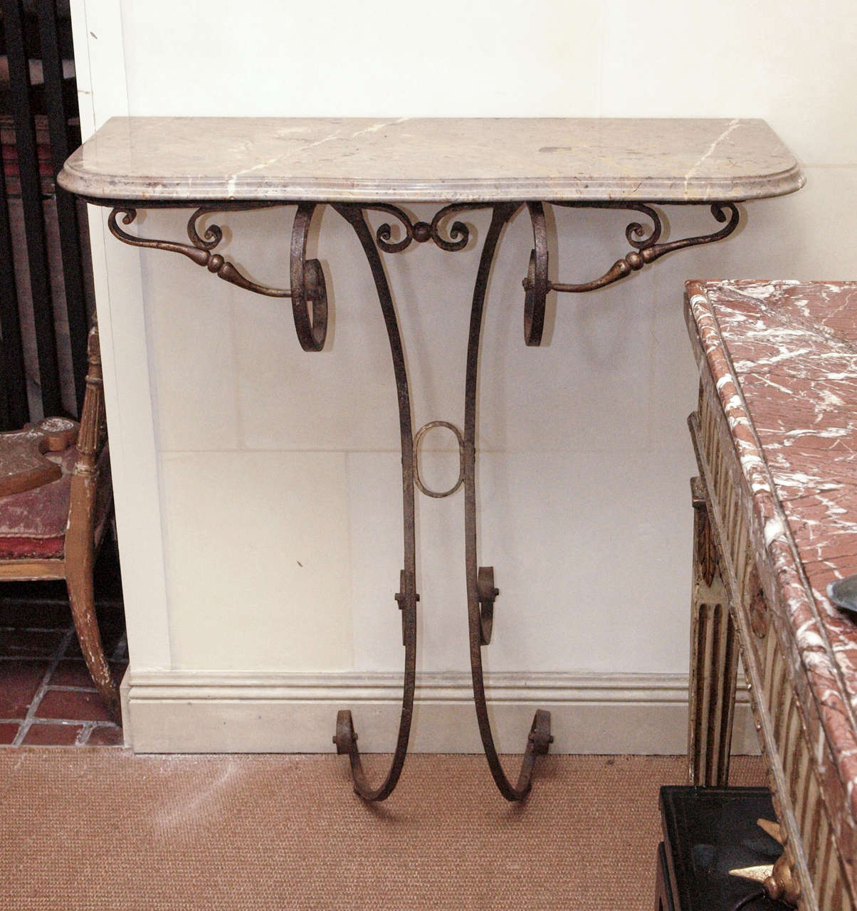 A 18th century French Rococo wrought iron wall console. The top is of sarrancolin marble. It shows well outdoors and indoors.