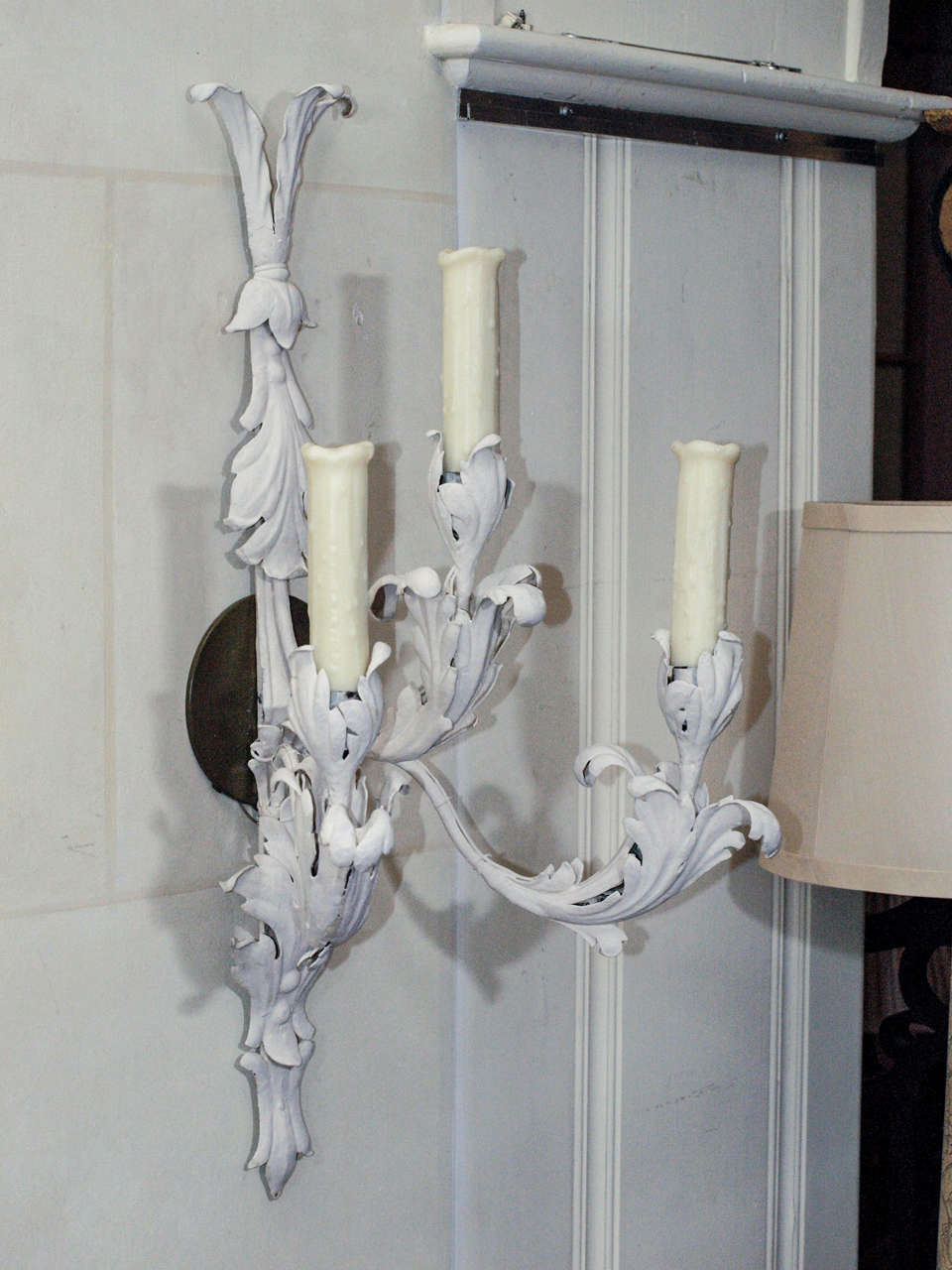 Graceful and elegant pair of 1930's three light  zinc sconces painted white from the Bagues workroom in France.
