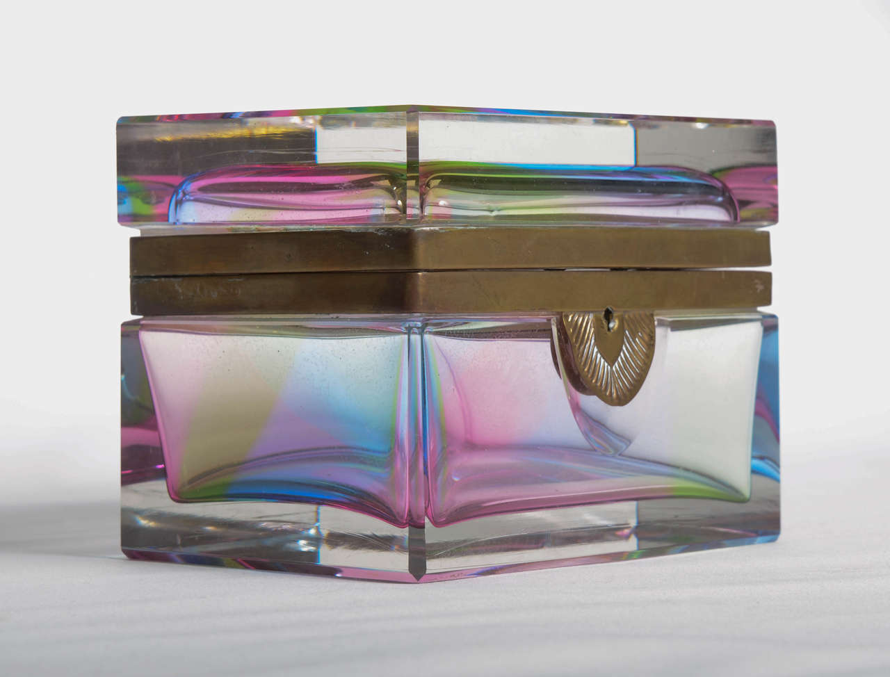 Thick glass with hinged lidded box featuring brass rimmed lid and base. Very elegant.