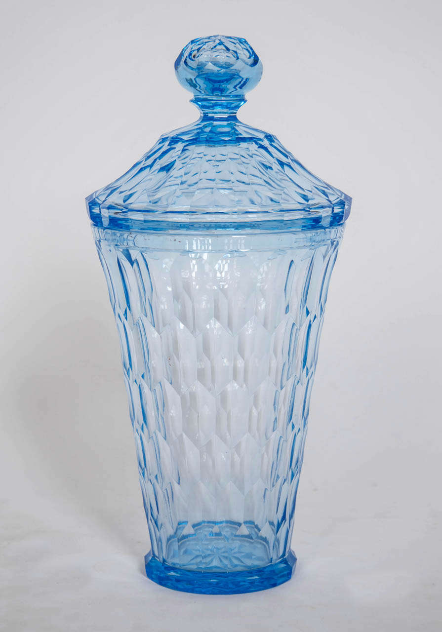 This fine early piece by Edward Hald is a brilliant blue faceted cut, tumbler form vase with a matching domed , finial mounted cover. On the base is the engraved mark 