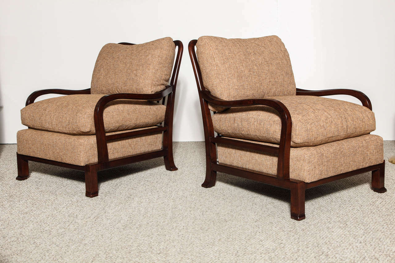 Dark stained wood frames with open arm and spindle back details.  Generously proportioned, and super comfortable.   The design of thses chairs dates back to the early 1940's.  These particular examples were part of a larger commision for a Beverly