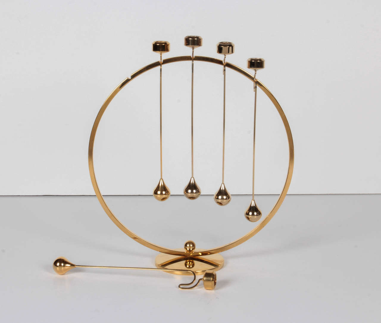 A beautiful sculptural brass candelabra with detachable pendulum candle-holders by Asmussen Denmark. It is certainly functional but looks amazing as a sculptural object as well. Maker's mark on bottom.