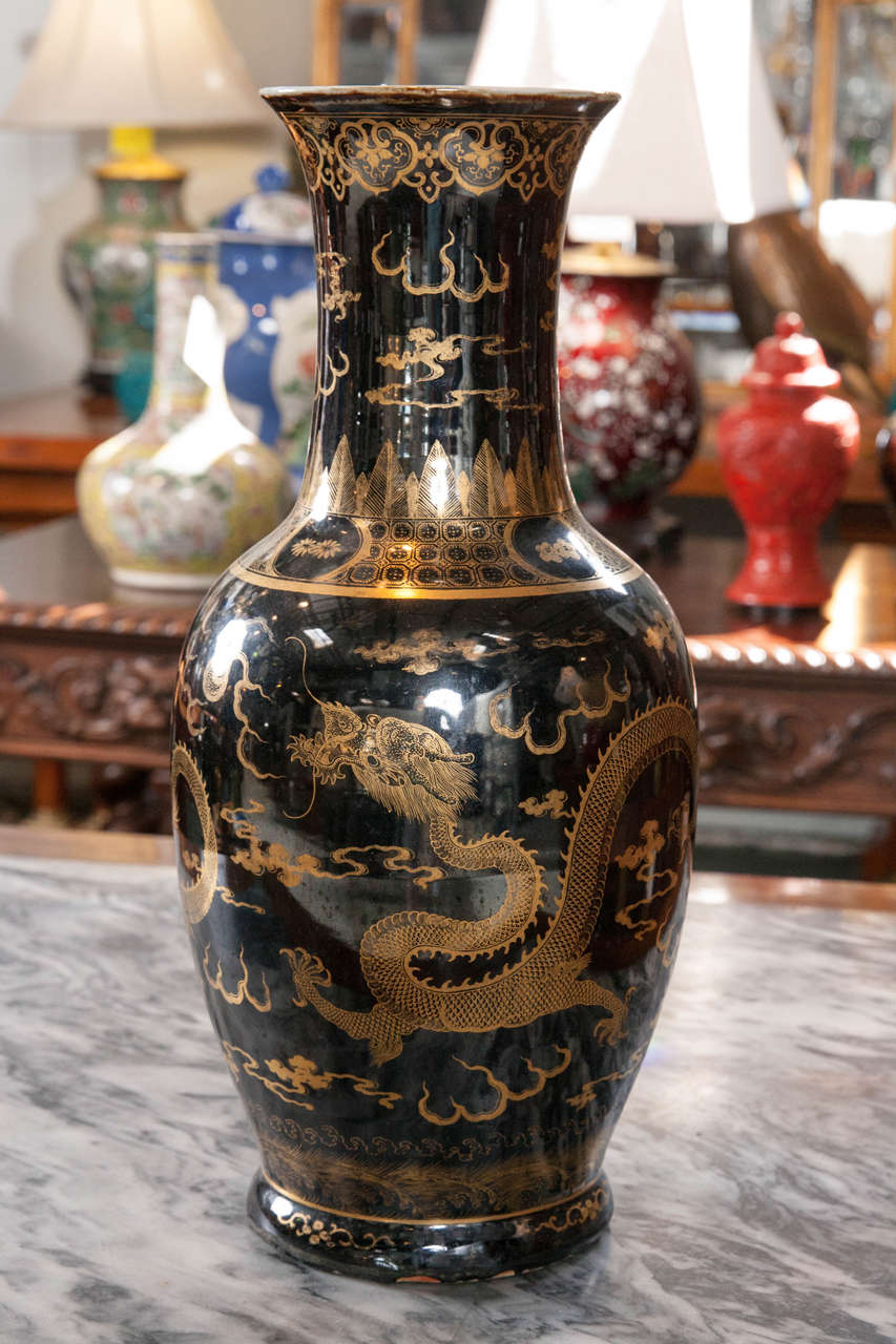 18th century, mirror black vase with gilded decoration of five clawed dragon in clouds.